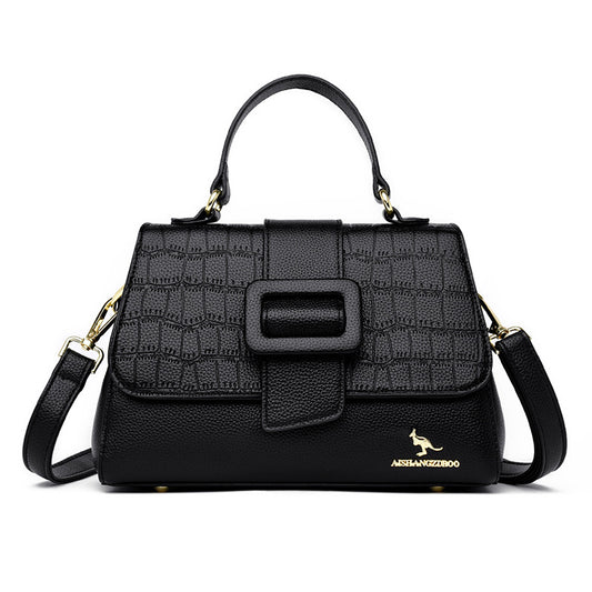 Black handbag with textured pattern and visible brand logo on a white background