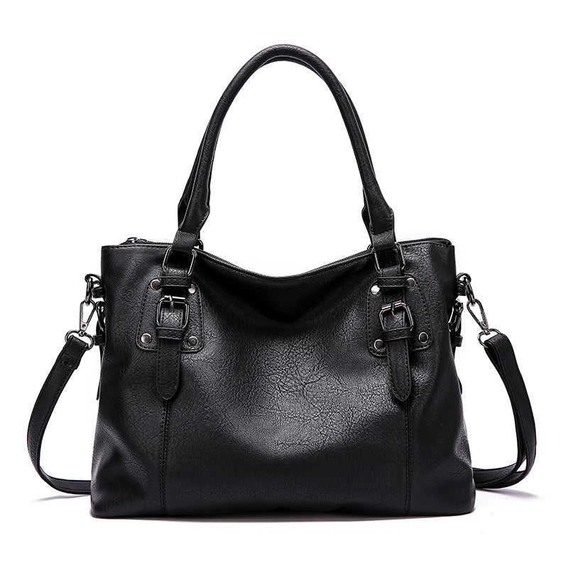 Black PU leather tote bag with dual handles and detachable shoulder strap.