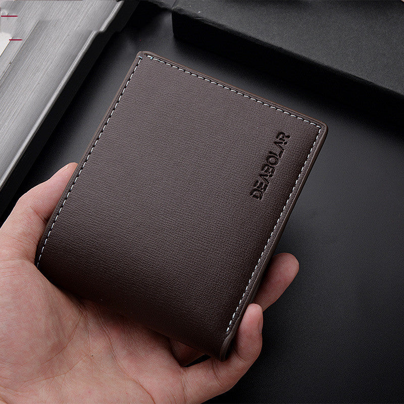 Deabolar Slim PU Leather wallet held in a hand with a dark background