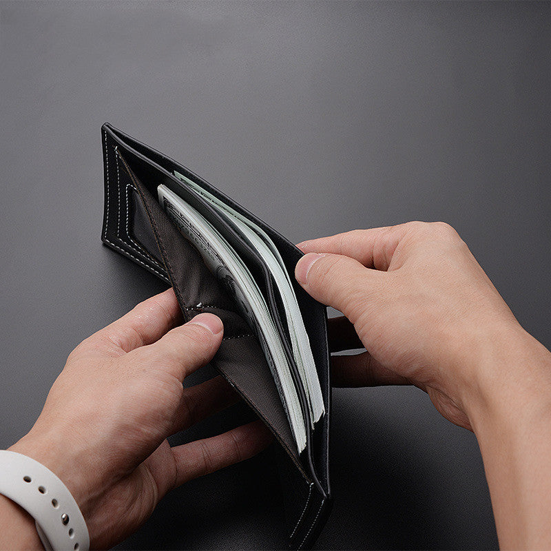 Deabolar open black bifold wallet showing interior cash compartment.
