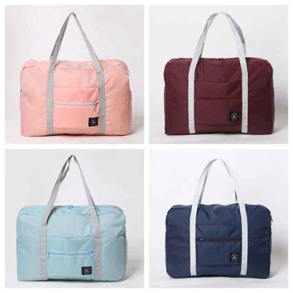 Foldable travel bag shown in pink, red, blue, and navy blue colors.