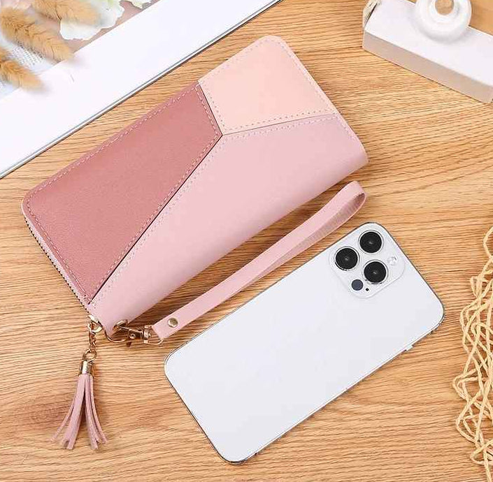 Long patchwork wallet shown beside a smartphone for size comparison