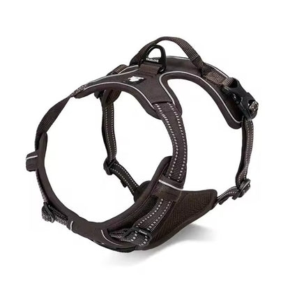 Black adjustable dog harness with reflective straps, padded chest panel, top control handle, and rear leash attachment ring.