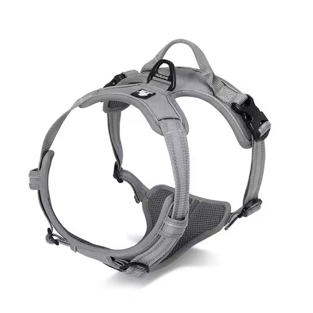 Grey adjustable dog harness with reflective straps, padded chest panel, top control handle, and rear leash attachment ring.